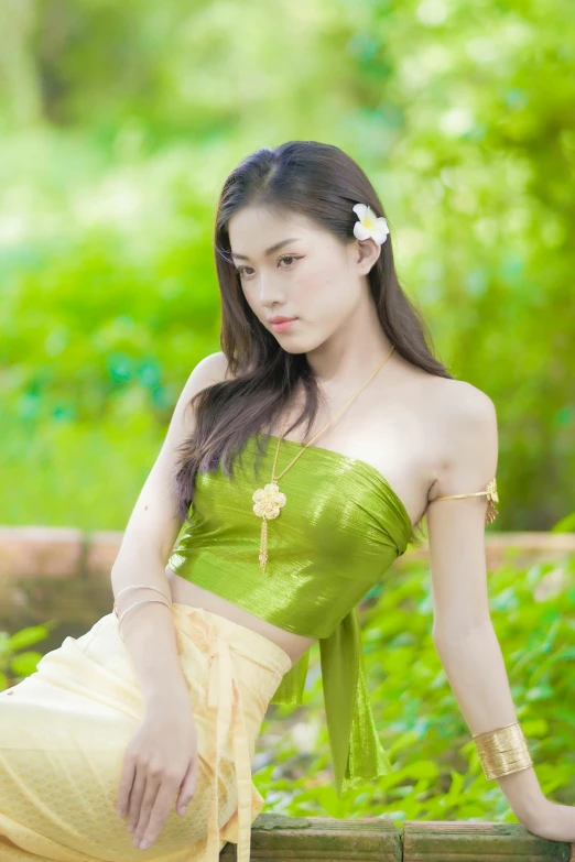 a beautiful young woman posing in a green dress