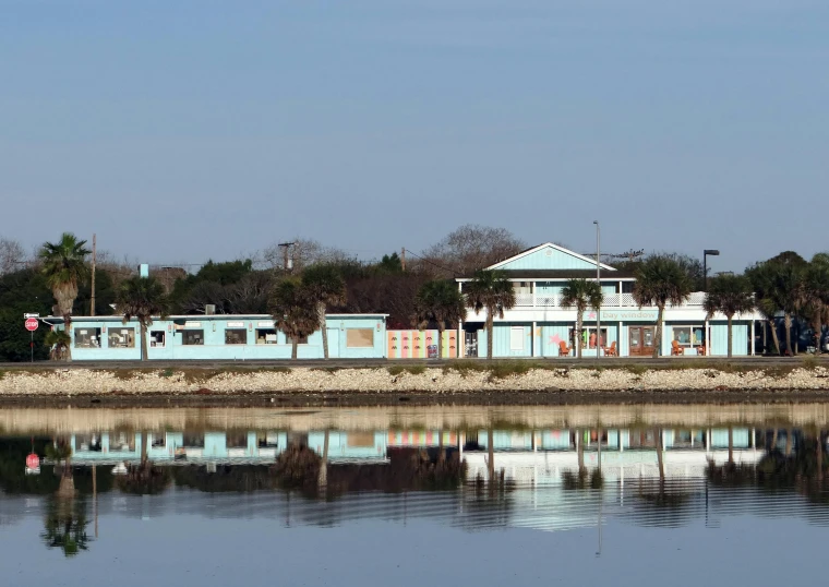 the buildings are blue in color reflected in the water