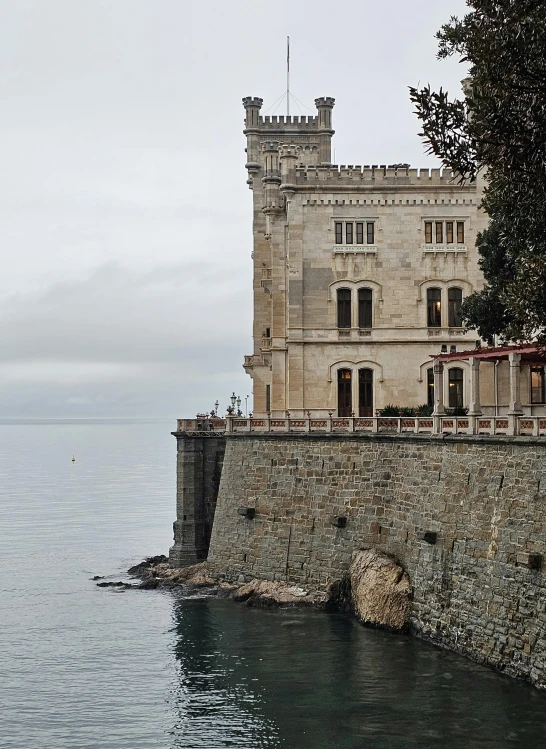 large stone building near large body of water