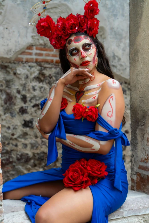 the woman is posing with her face painted in white and red