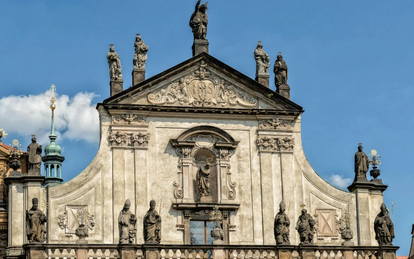 an ornate building with statues around it on a clear day