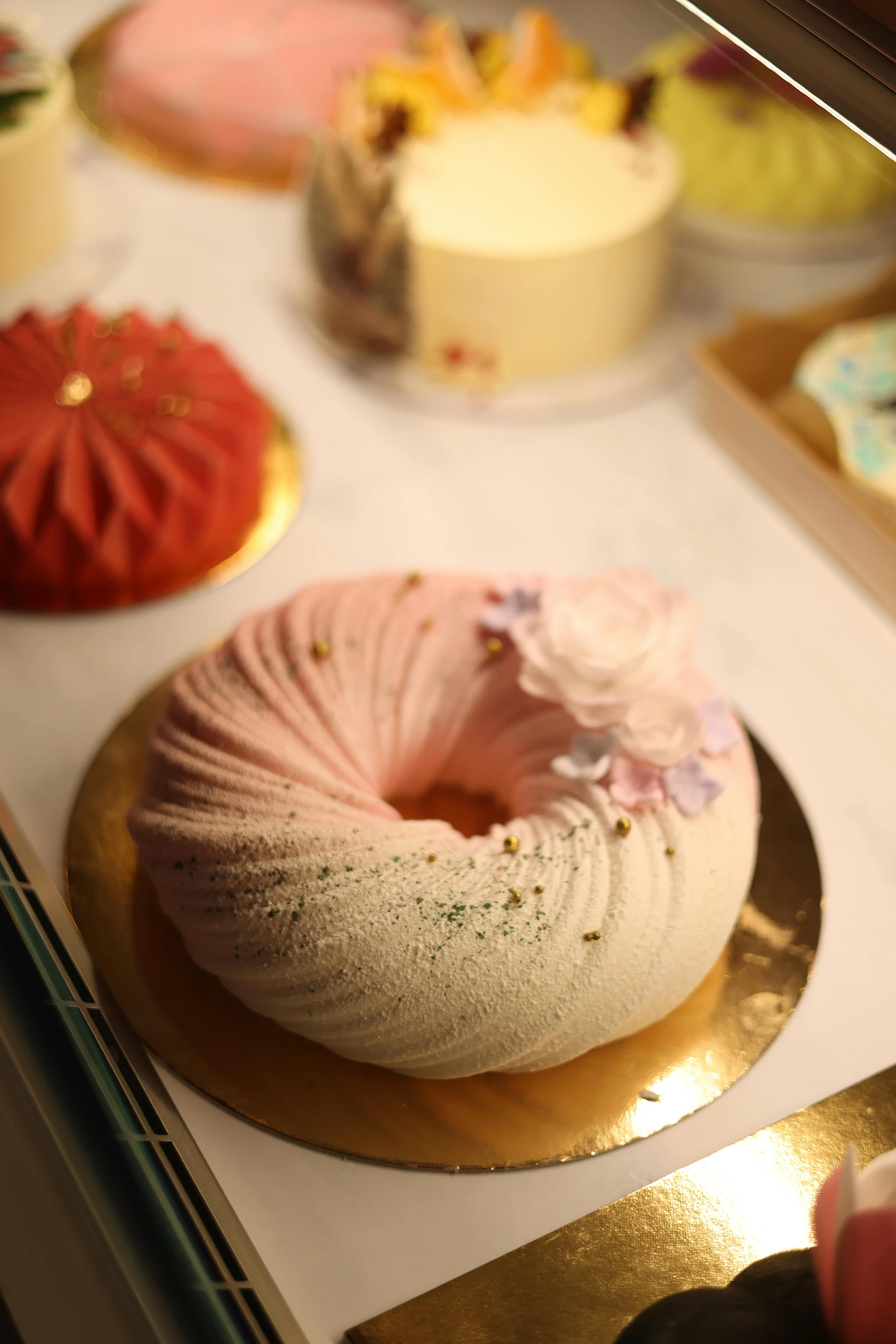 a dessert cake that is on display behind a display