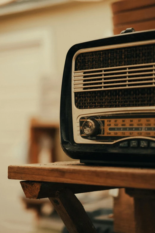 an old radio sitting on top of a wooden table