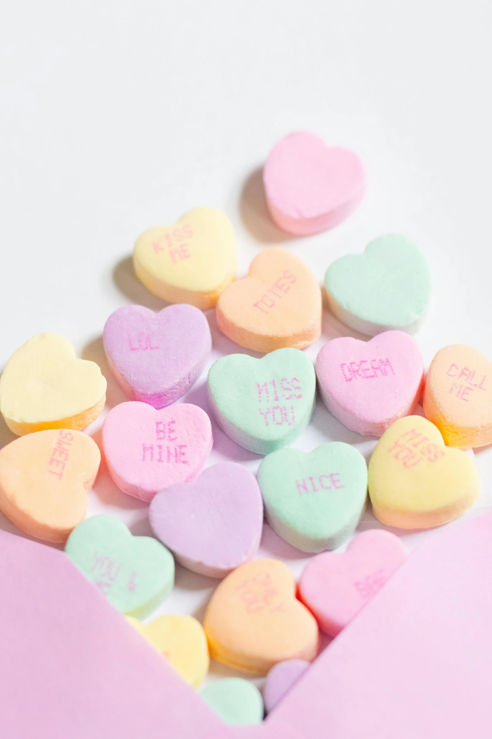 conversation hearts are shown sitting in a pile