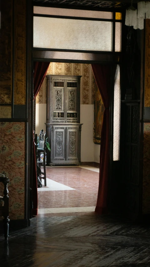 an old, antique style cabinet with curtains in a room