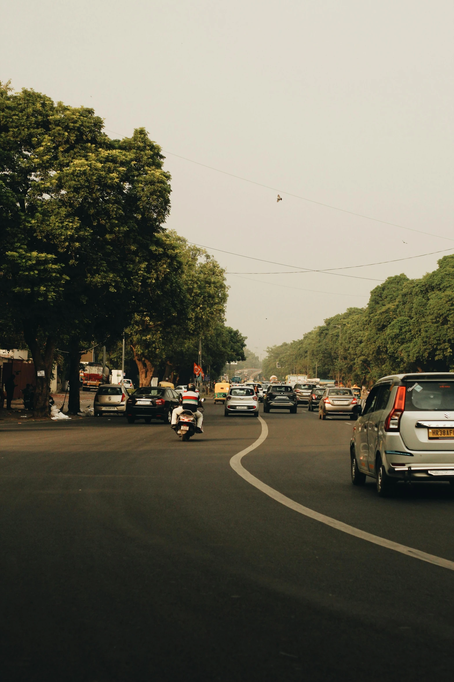 cars in traffic at an intersection on a sunny day