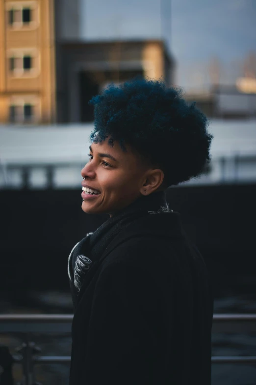 a man is smiling while walking down the street