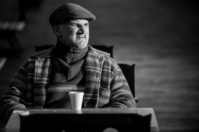 black and white pograph of an elderly man with hat