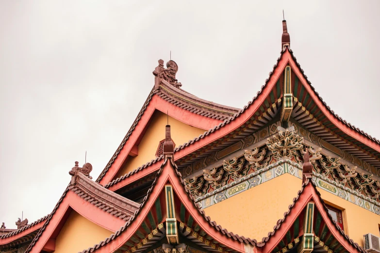 an asian style structure with red roof tiles