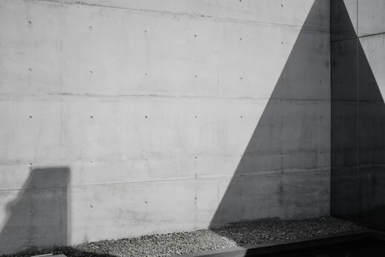 a shadow is cast on the concrete outside of a building