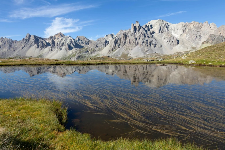 a small body of water in the middle of a mountain range