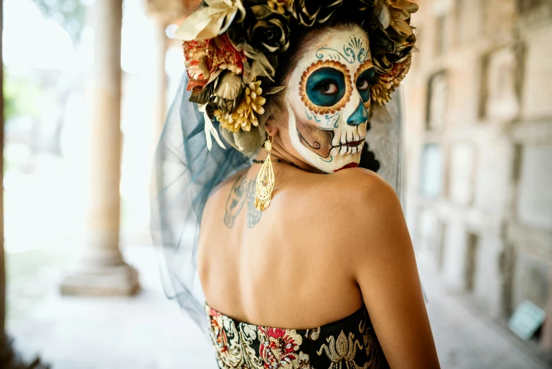 a woman with face paint decorated with flowers