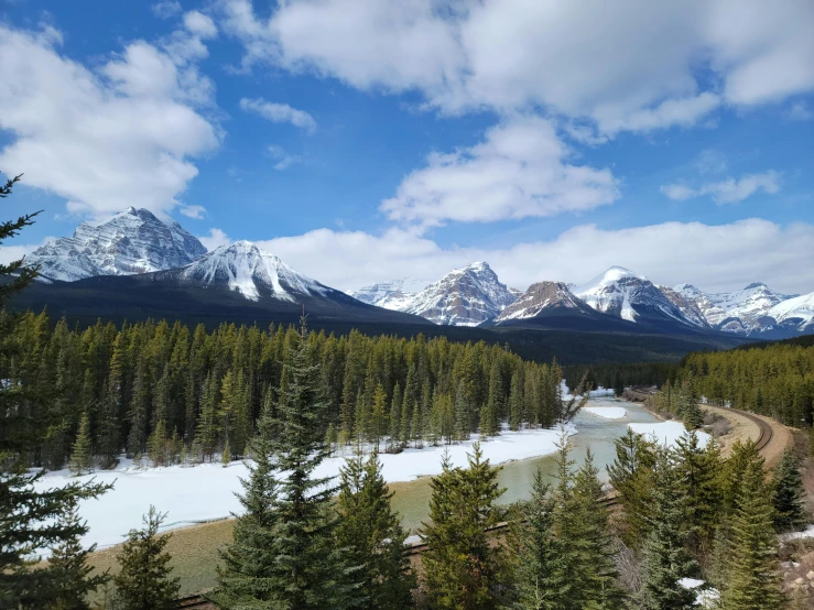 the mountains are covered in snow and trees