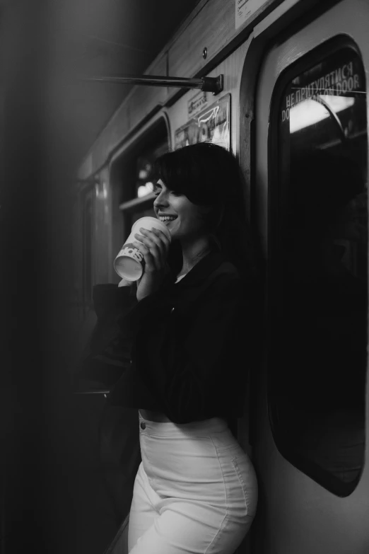 a woman on a subway talking on her cell phone