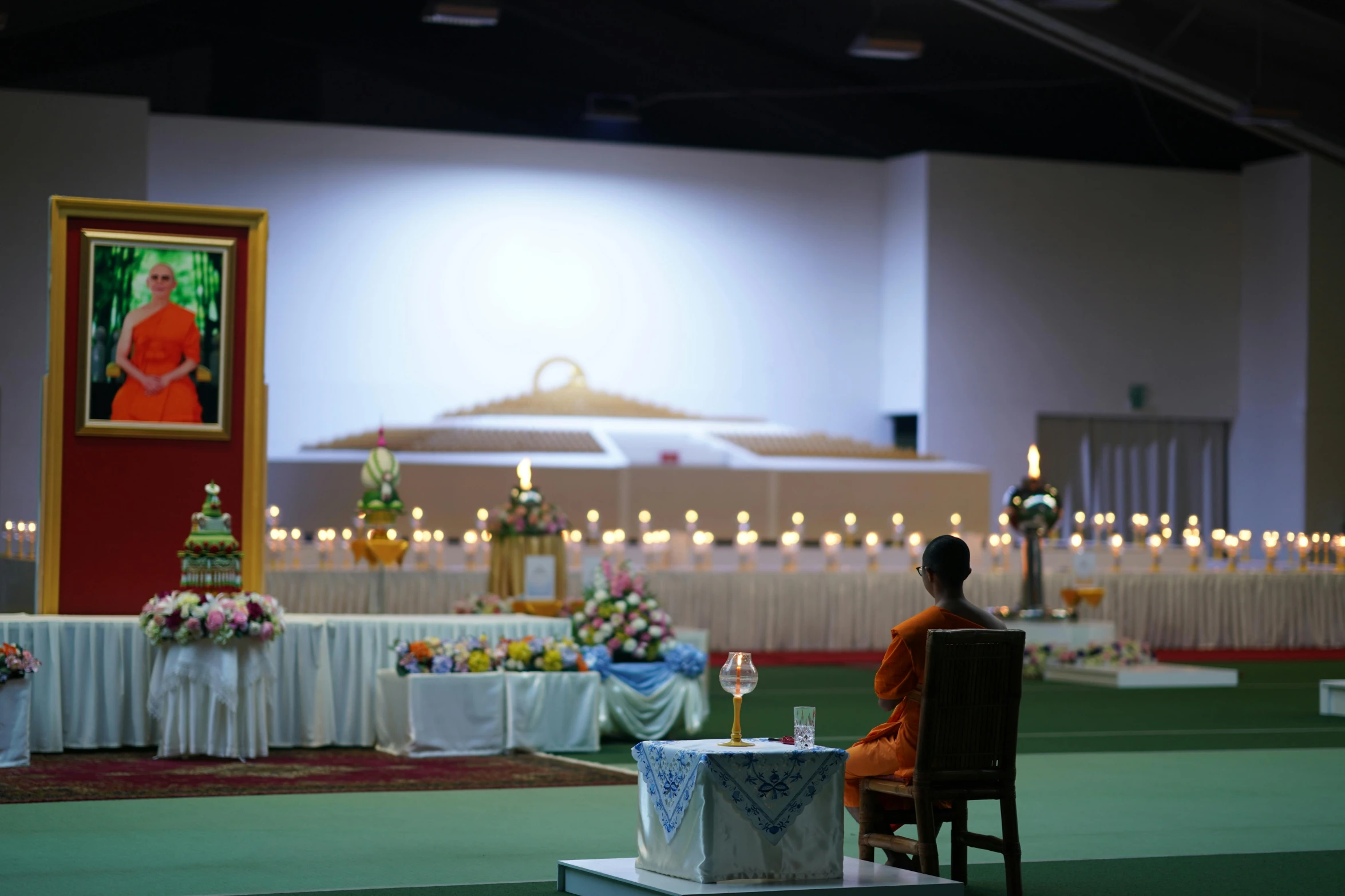 a man is sitting in a chair at the alter