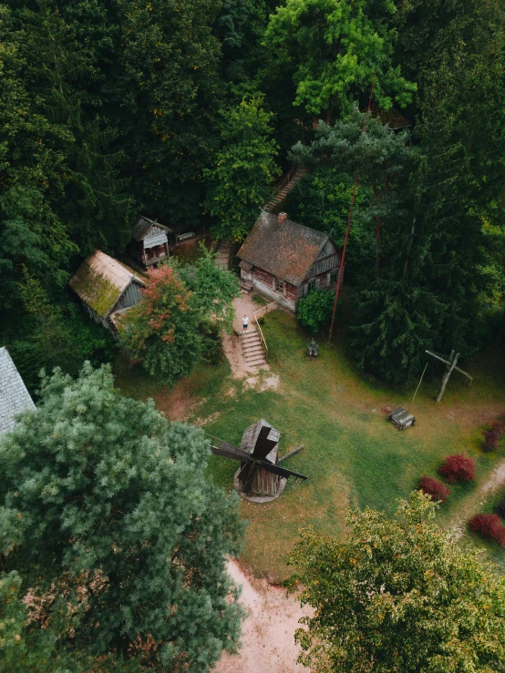 the aerial view of an abandoned home in the woods