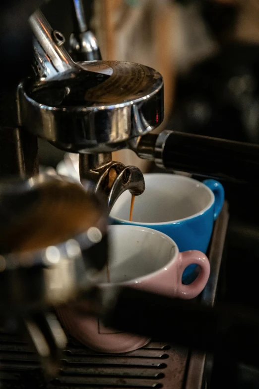 a coffee machine is pouring milk in a cup