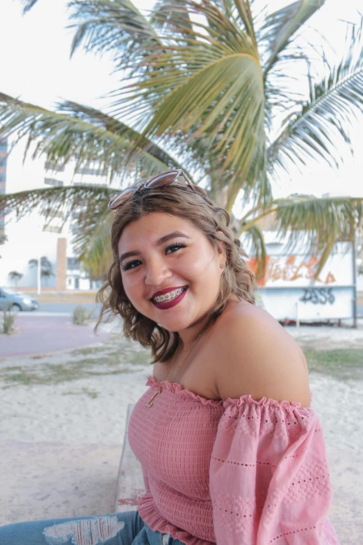 a young lady with a smile on her face posing for the camera