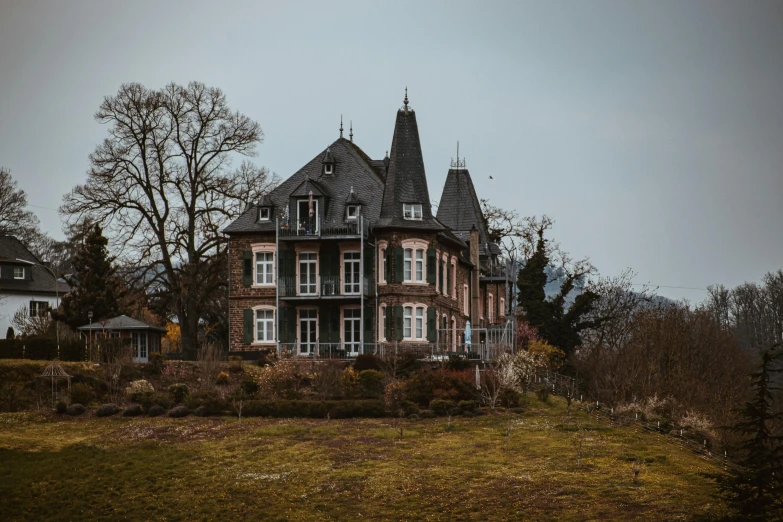 the view of an old victorian style house in the country