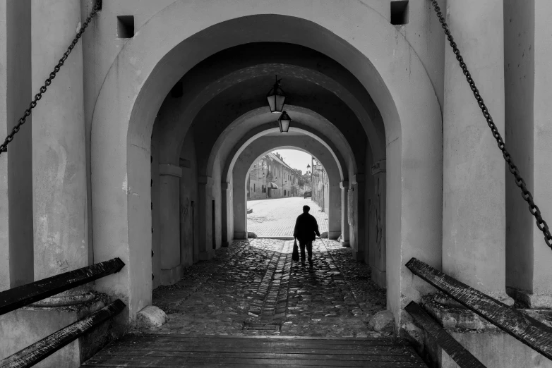 an old man is seen walking down the walkway