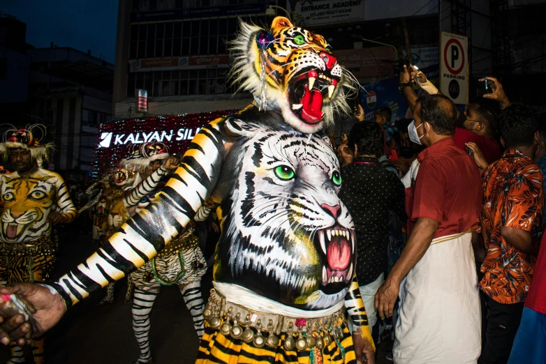 a man dressed as a tiger walks on the street