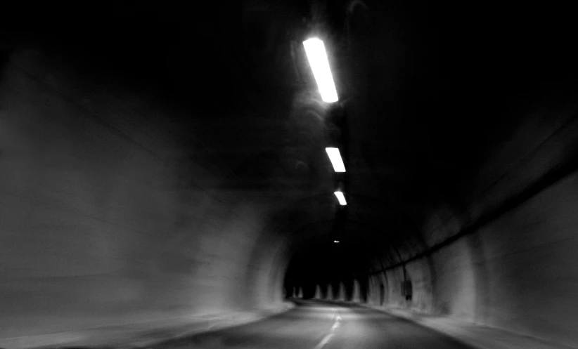 a man riding on the back of a motorcycle through a tunnel