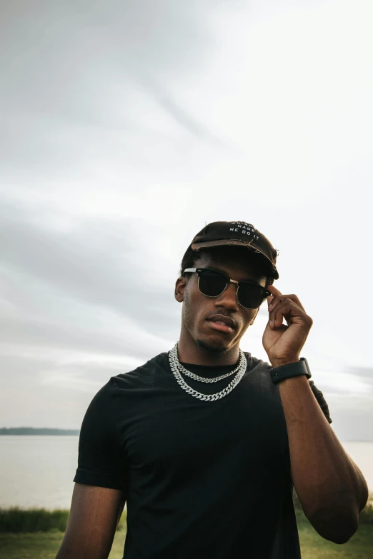 an african american man in sunglasses and a cap