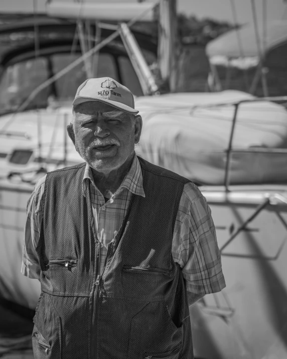 a man stands in front of some boats