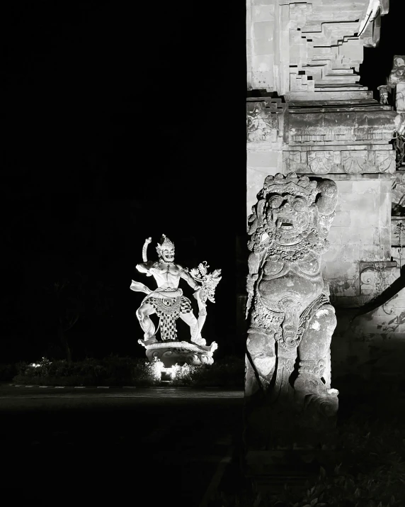 a statue with a black and white background