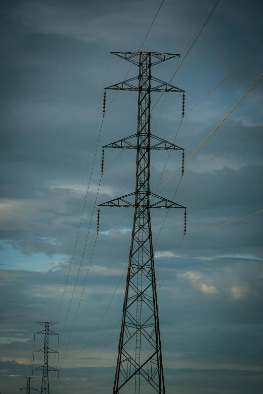 electrical towers are shown against a dark blue sky
