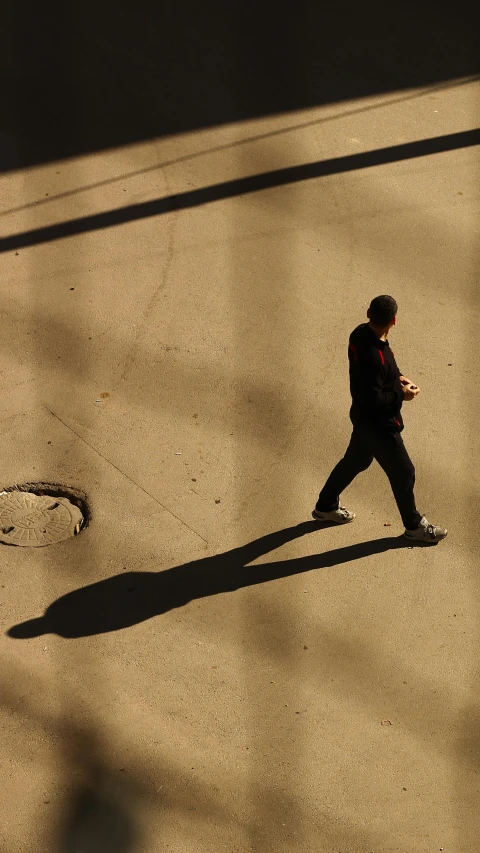 a young man is walking down the street