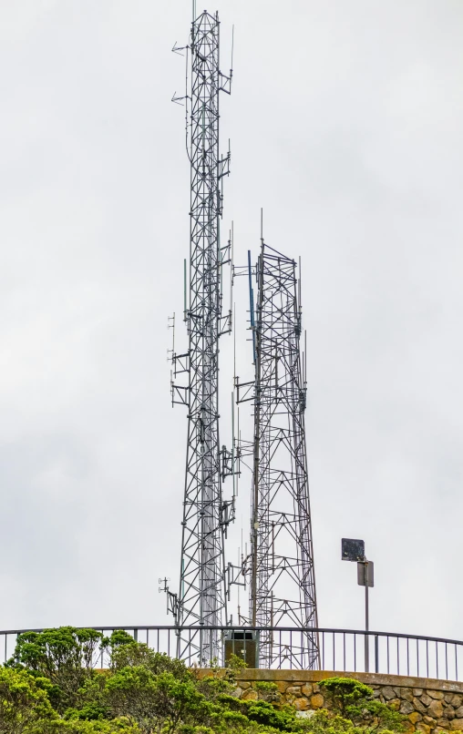 the clock tower is covered in scaffolding on the top of the hill