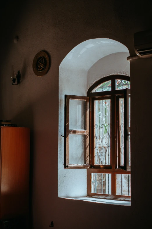 an arched window with two small bars in front of it