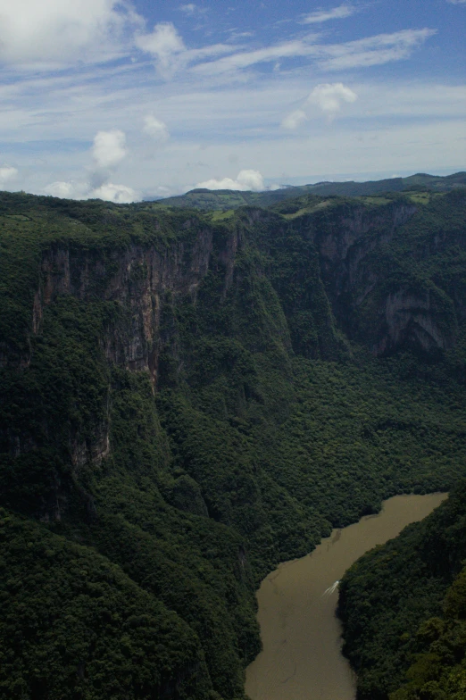 an aerial view of a valley with some mountains in the background