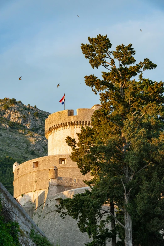 a stone castle built into the side of a mountain