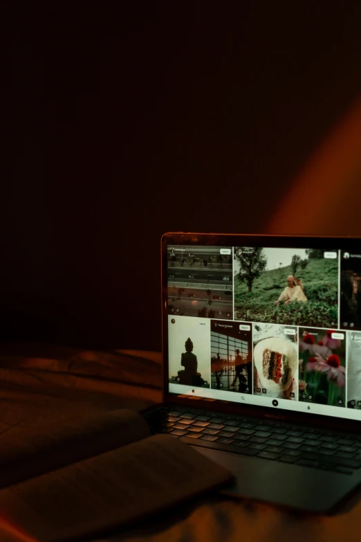 a laptop computer on a dark surface with some images being taken