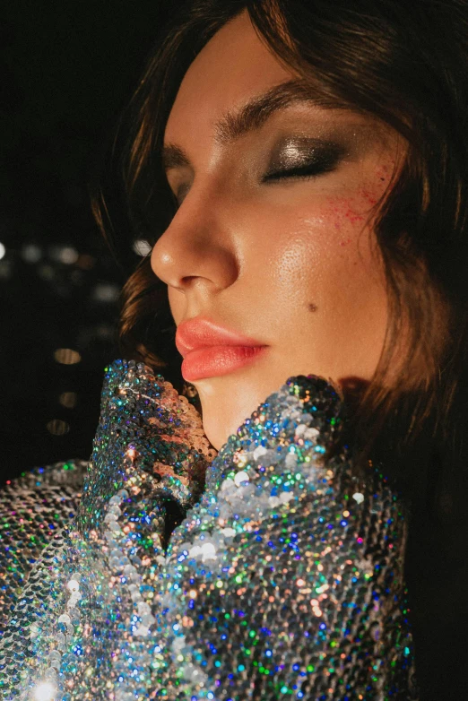 a woman posing in front of a camera with her hands on her face