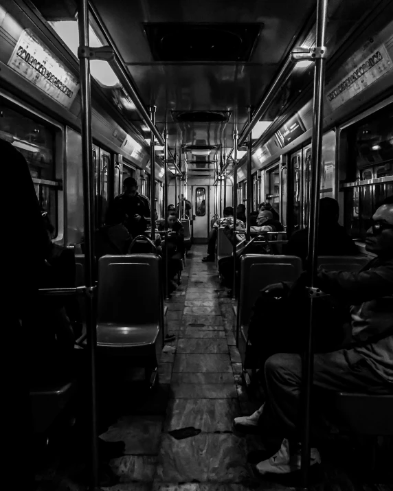 several people sitting on a passenger train looking inside