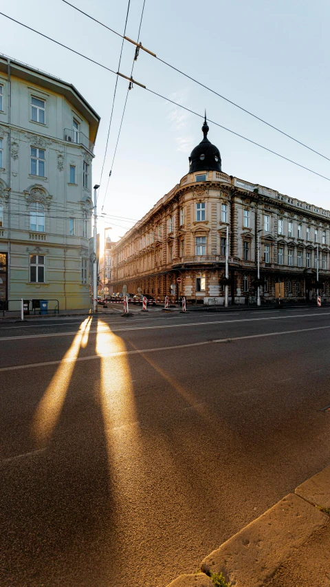 a deserted city street with an old building next to it