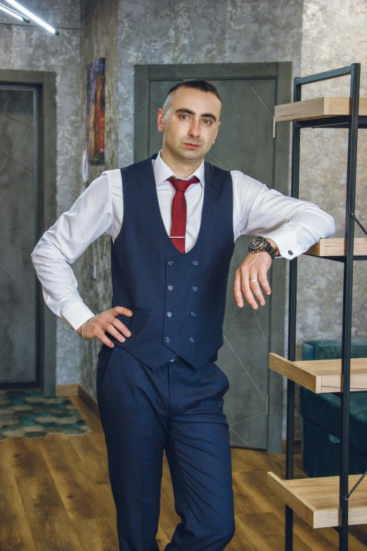 a man in a suit and red tie is posing