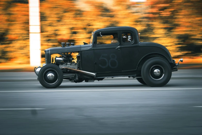 an old model  rod in motion on the road