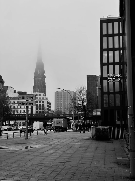 an empty city street is shown with tall buildings