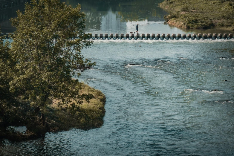 a body of water with a small bridge next to it