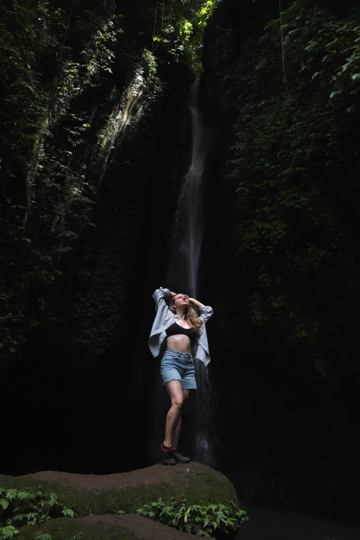 this is a po of a person with shorts on by a waterfall