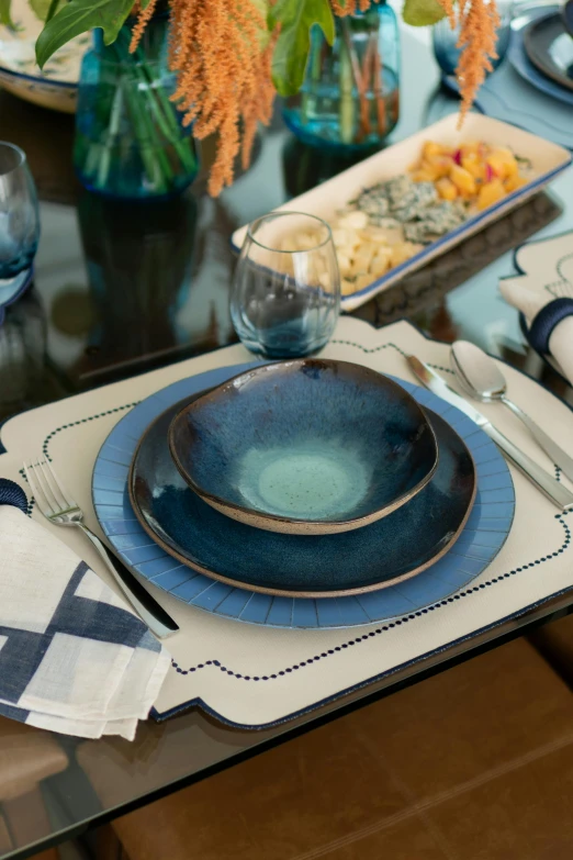 a table with blue plates and utensils on it