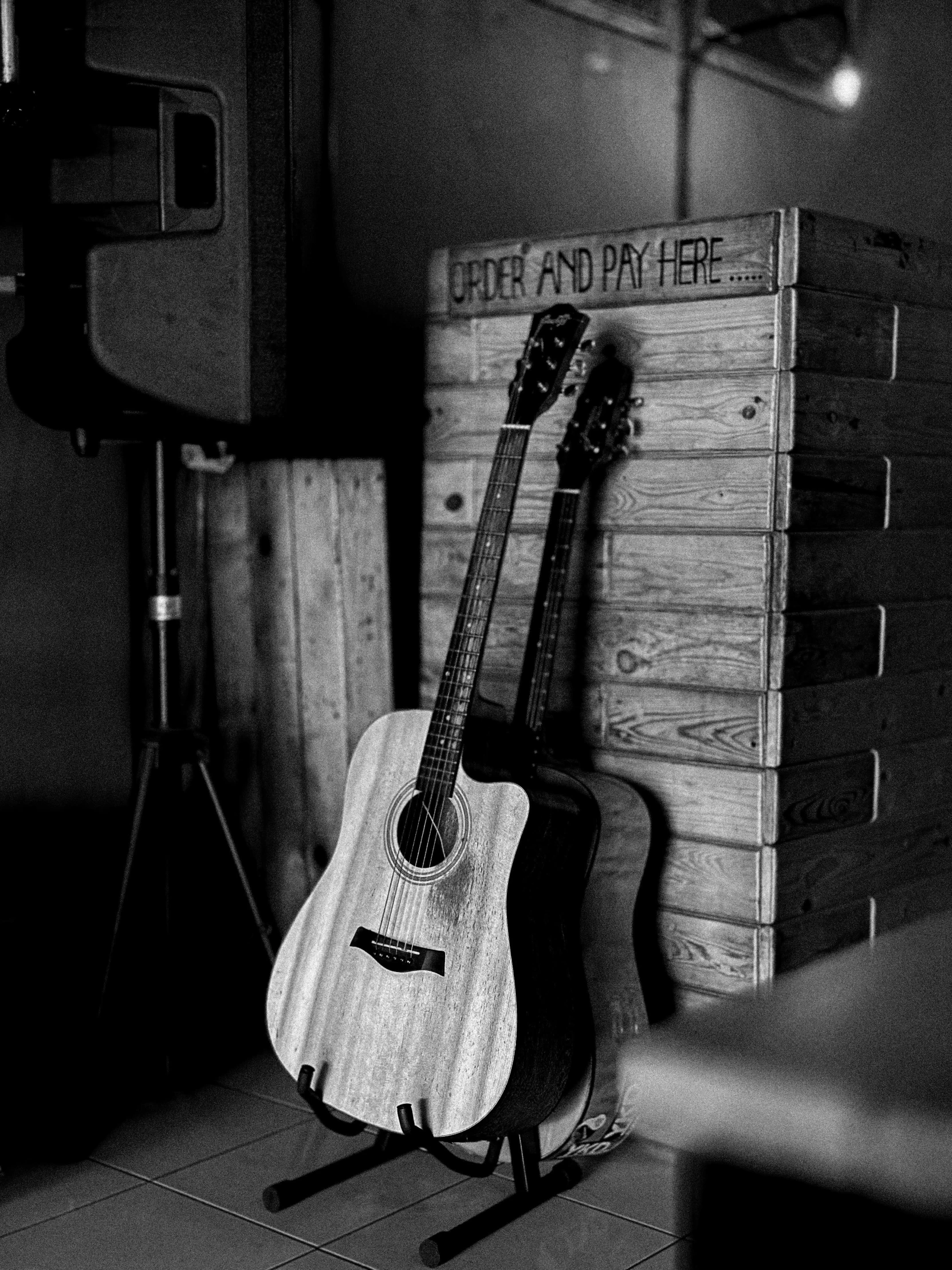 black and white po of guitars on floor