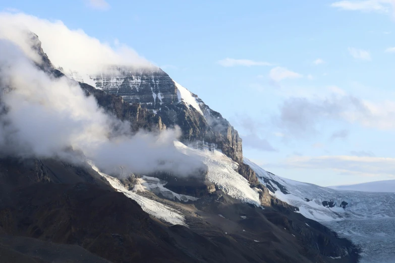 two skiiers are on the snow covered mountains