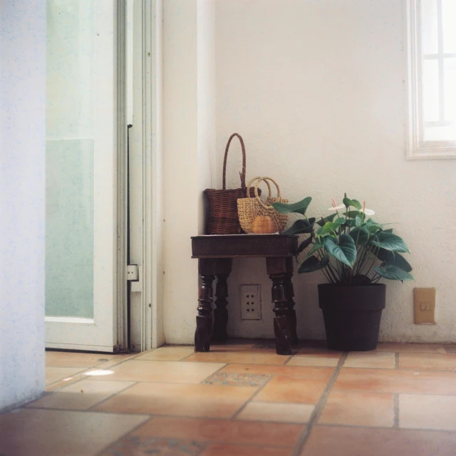 a small desk sits on the floor near a window