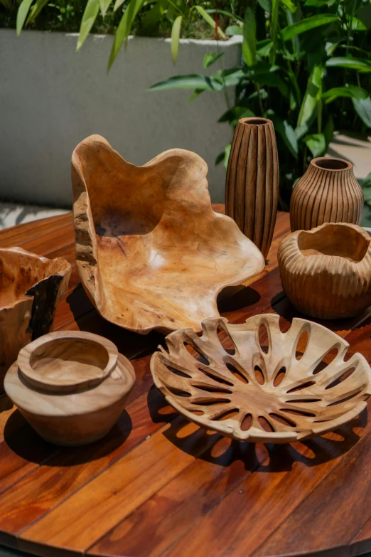 some pottery sits on a wooden table