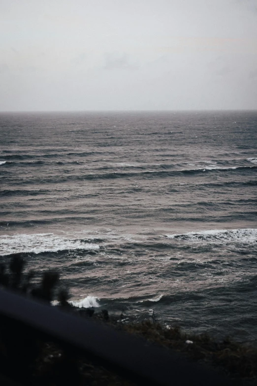 people are in the water on surfboards near the ocean